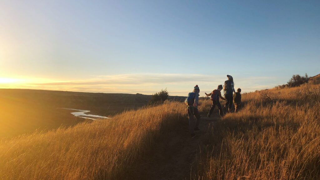 Kids wearing hiking gear on a family trail adventure